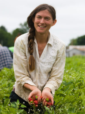 farmer Sarah Voiland with strawberries in field